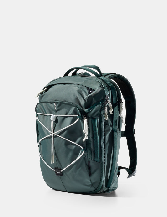 Green backpack with white accents on a light gray background