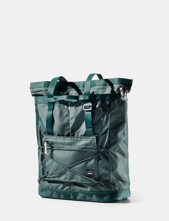 Green tote bag with multiple pockets on a white background