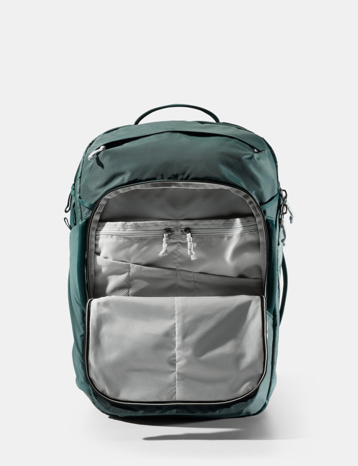 Green backpack with a gray interior on a white background