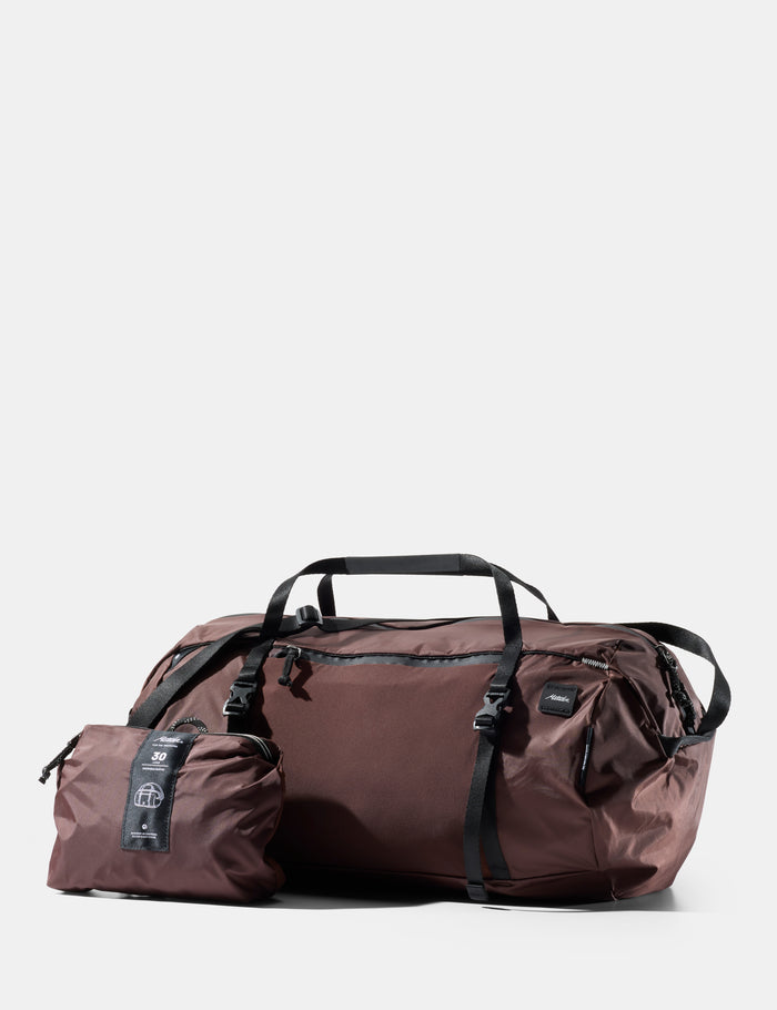 garnet duffel bag with a smaller pouch on a white background