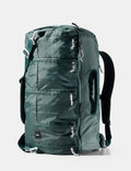 Green backpack with multiple zippers on a white background