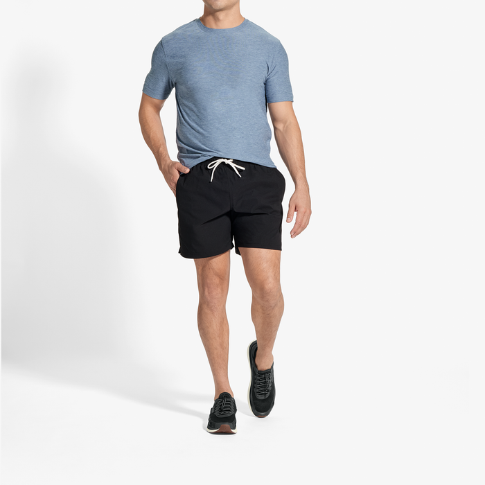 Man wearing blue-gray t-shirt and black shorts with drawstring waistband.