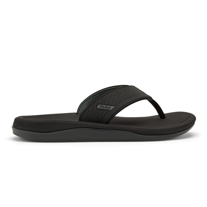 Black flip-flop sandal with textured strap and cushioned sole, shown in side profile.