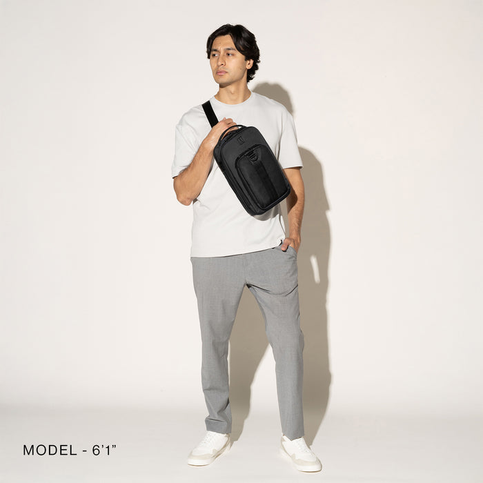 Person wearing a black crossbody over the shoulder on a white background