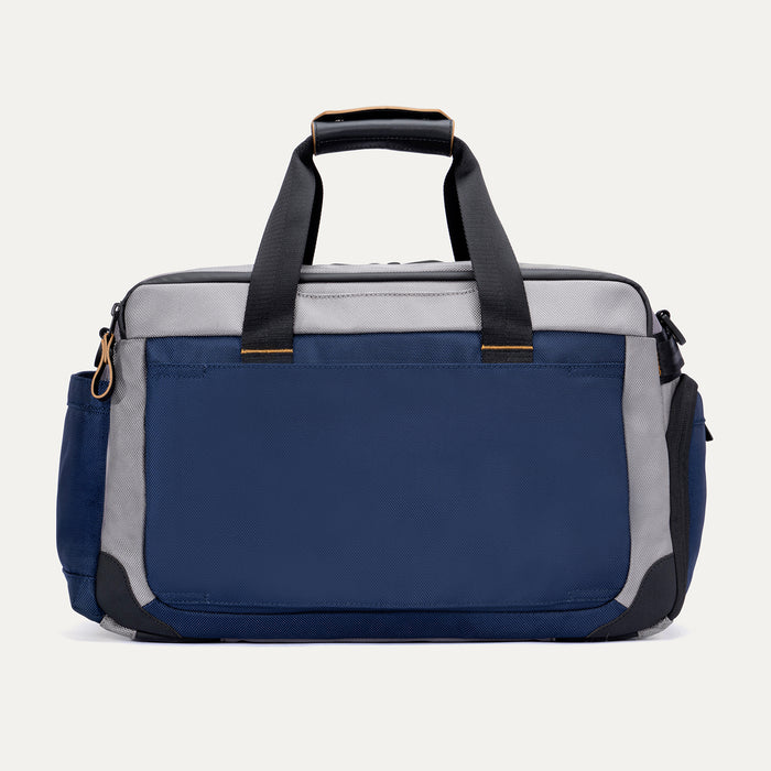 Rear view of the Travelpro Altitude Day-to-Day Duffel in Stellar Navy/Grey, showing rear pocket and dual carry handles.