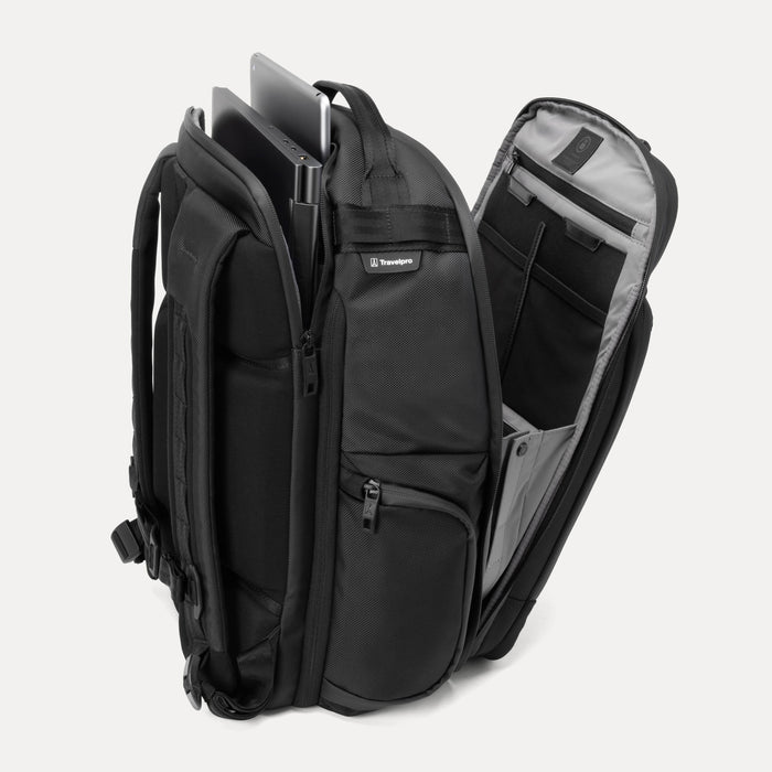 Side view of the Travelpro Altitude Large Expandable Laptop Backpack in Falcon Grey, showing the open laptop compartment with a computer, tablet, and accessories neatly arranged inside.