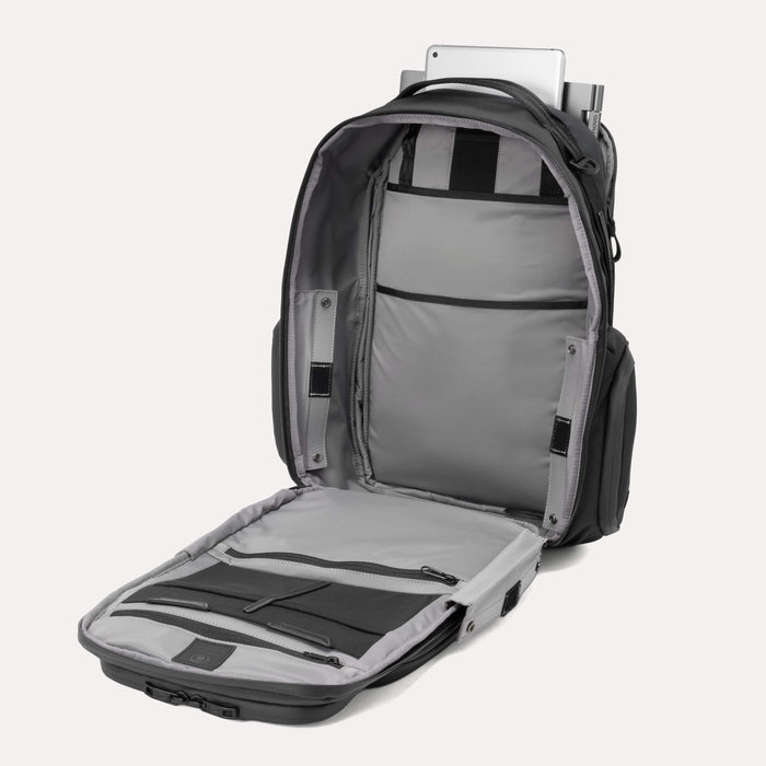 Open view of the Travelpro Altitude Large Expandable Laptop Backpack in Black, showing organized interior compartments with padded laptop and tablet sleeves against a light background.