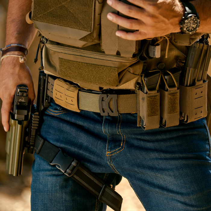 Man Wearing a Kore Essentials Ranger Green Molle Battle Belt with Kore Essentials Attachments Equipped to the Belt