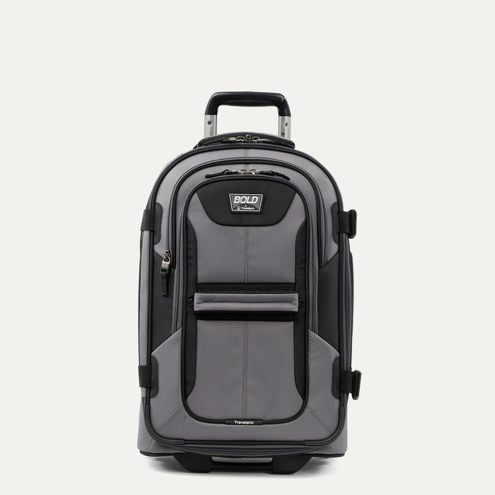 front view of the gray black bold by travelpro carry-on expandable rollaboard suitcase standing upright, showcasing its rugged black and gray polyester exterior, front zippered pocket, sturdy top carry handle, and extended telescoping aircraft-grade handle.