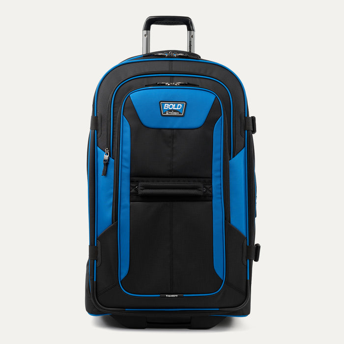 front view of the blue black bold by travelpro large check-in expandable rollaboard suitcase standing upright, showcasing its rugged black and blue polyester exterior, spacious front zippered pocket, sturdy rubberized carry handle, and extended telescoping aircraft-grade handle.