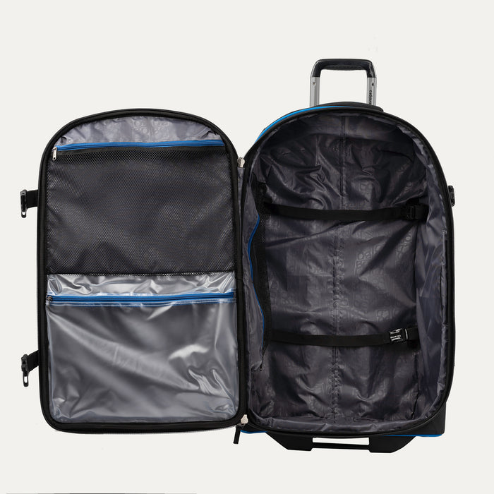 interior view of the open blue black bold by travelpro large check-in expandable rollaboard suitcase showing a spacious main compartment with two adjustable hold-down straps and a large zippered mesh lid pocket alongside a clear plastic wet pocket with blue zipper trim.