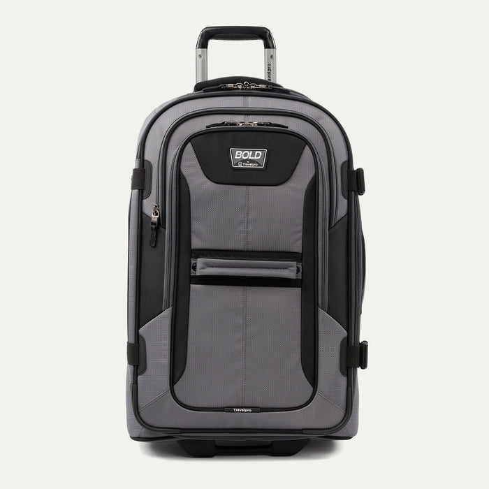 front view of the gray black bold by travelpro medium check-in expandable rollaboard suitcase standing upright, showcasing its rugged black and gray polyester exterior, spacious front zippered pocket, sturdy rubberized carry handle, and extended telescoping aircraft-grade handle.