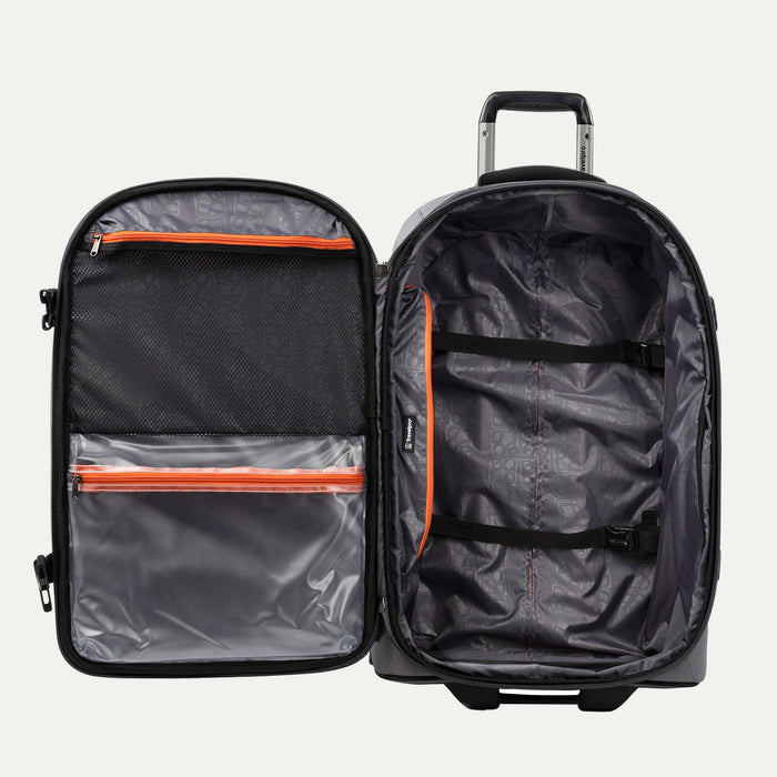 interior view of the open gray black bold by travelpro medium check-in expandable rollaboard suitcase showing a spacious main compartment with two adjustable hold-down straps and a large zippered mesh lid pocket alongside a clear plastic wet pocket with orange zipper trim.