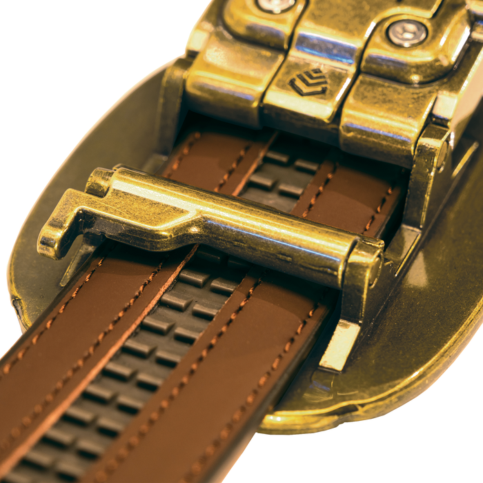 Close-up shot of a Kore Essentials brown leather ranch series gun belt with a brass Ranch series buckle. The micro-adjustable track system is shown