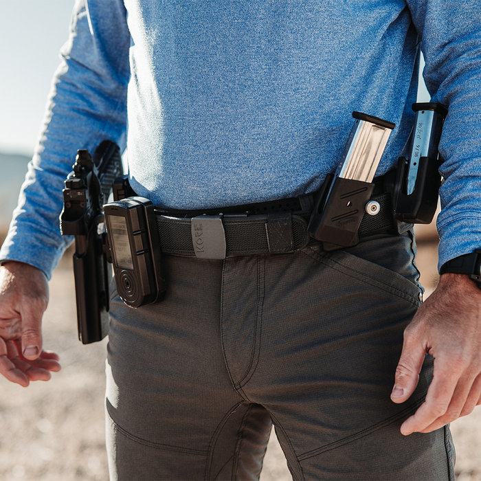 Closup of a man in blue wearing a black Kore Essentials reinforced competition shooting gun belt with a C1 buckle