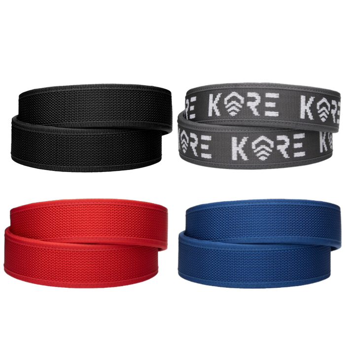 Four Kore Essentials competition belts in black, gray, red, and blue with 'Kore' branding on a white background.