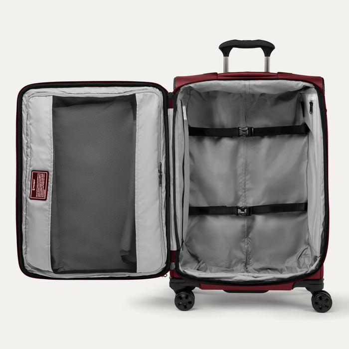 Interior view of Crew™ Classic Spinner in Rosewood Red, featuring adjustable compression straps and a zippered mesh divider.