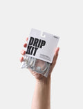 Hand holding a 'Drip Kit' packaging against a white background