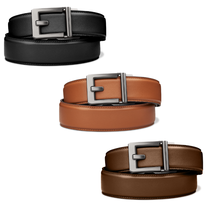 A collection of Kore Essentials X3 Leather EDC Gun Belts. Shown are one black leather gun belt with an X3 buckle, one tan leather EDC gun belt with an X3 buckle, and one brown EDC gun belt with an X3 buckle.