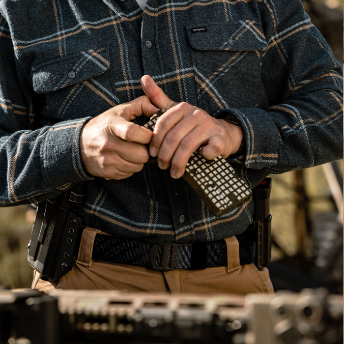 Man Wearing a Kore Essentials Black Nylon Gun Belt with an X7 Buckle
