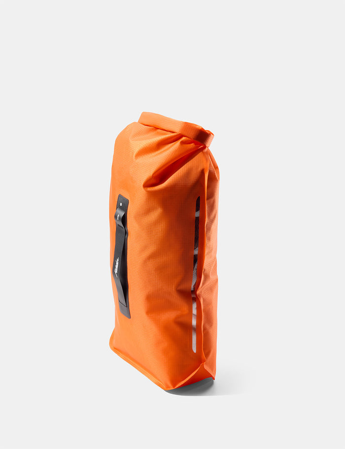 Orange dry bag with a black label on a white background