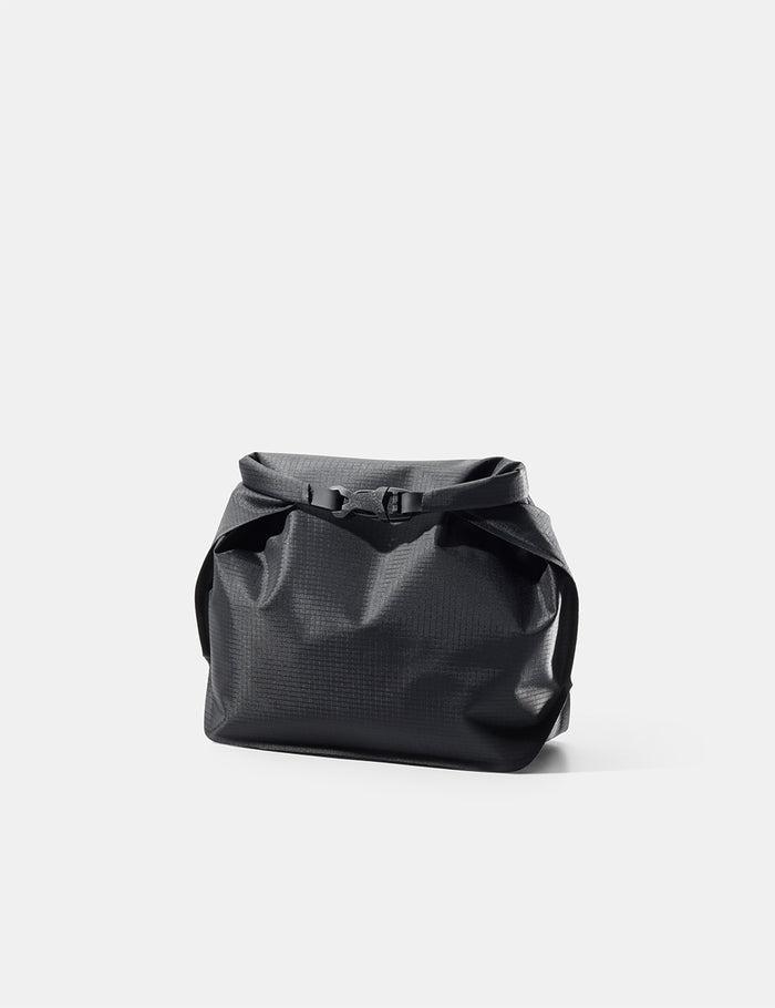 Black toiletry case on a light gray background