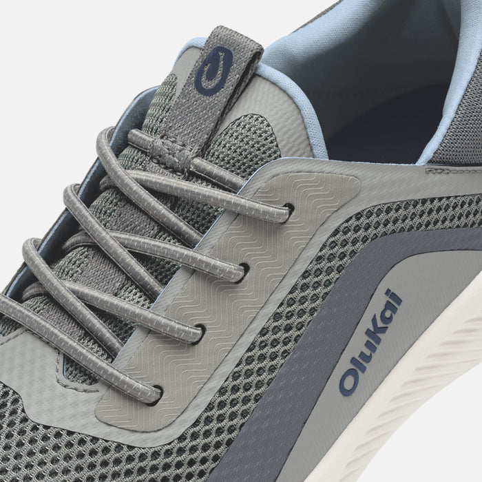 Charcoal and light blue athletic shoe with mesh panels, textured sole, and gray laces.