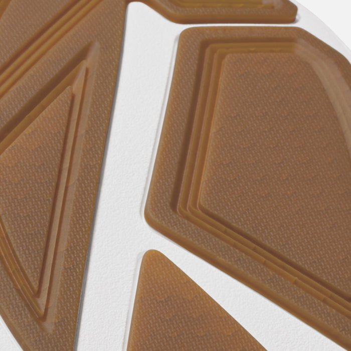 Tan and white textured sole with geometric groove patterns and raised edges.