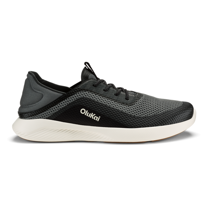 Dark gray and black Olukai Kialoa running shoe with white sole, shown in side profile.