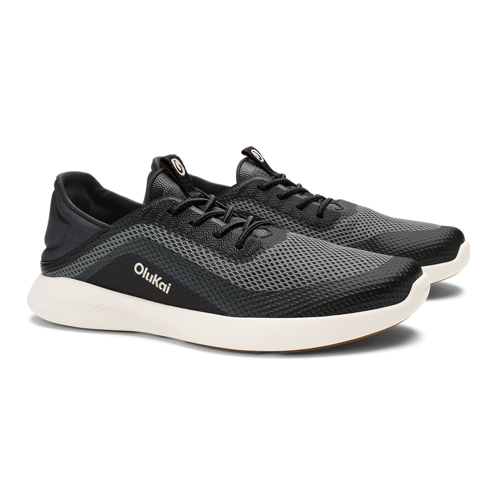 Black mesh athletic shoe with white sole and OluKai branding on the side.