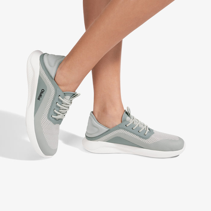 Kialoa sneaker in sterling gray and white with mesh panels and white sole, shown on feet from side angle.
