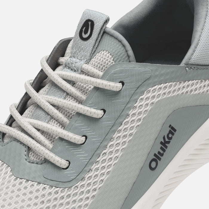 Gray and white athletic shoe with white laces, mesh panels, and Oiikai branding on the side.
