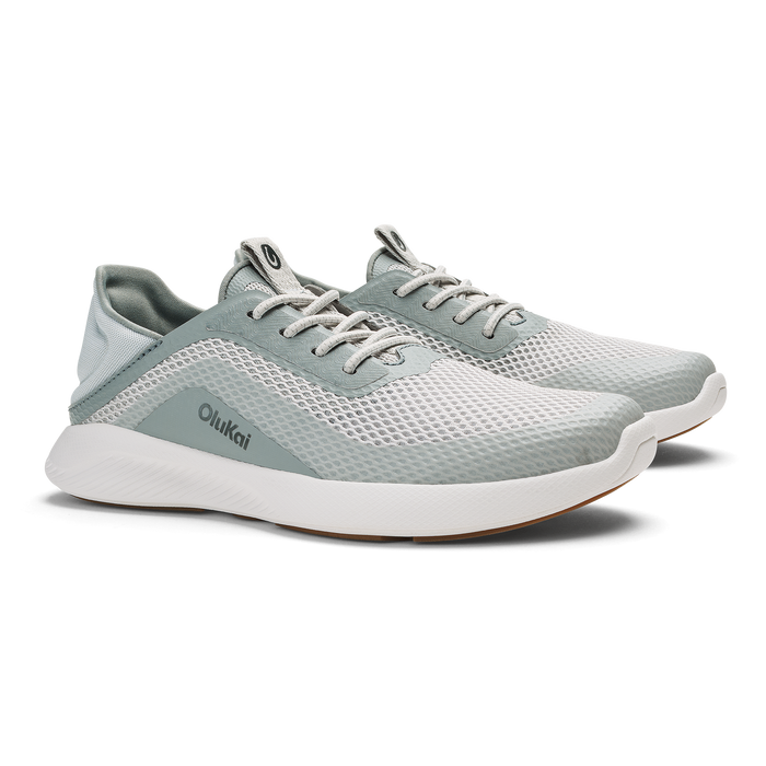 Pair of Olukai Kialoa running shoes in sterling gray and cream with mesh upper and white sole.