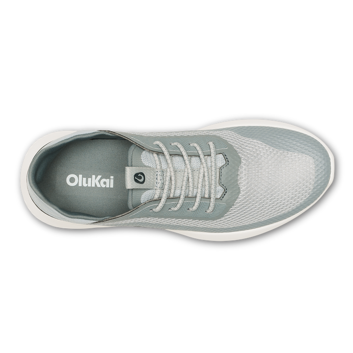 Top view of a gray and white OluKai lace-up sneaker with white sole and mesh upper.