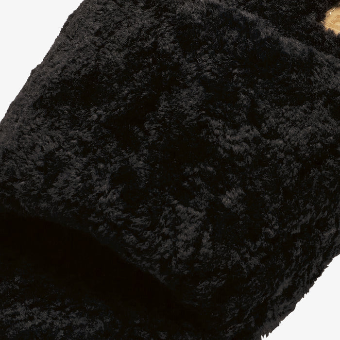 Black textured fabric with quilted pattern and gathered construction detail.