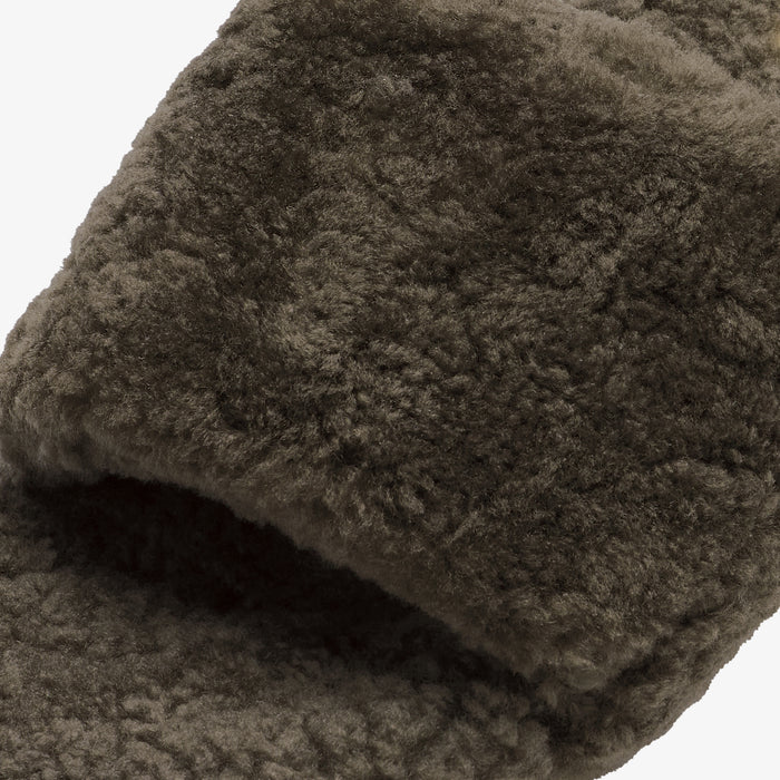 Walnut-colored textured fabric with plush pile shown folded to display depth and surface detail.