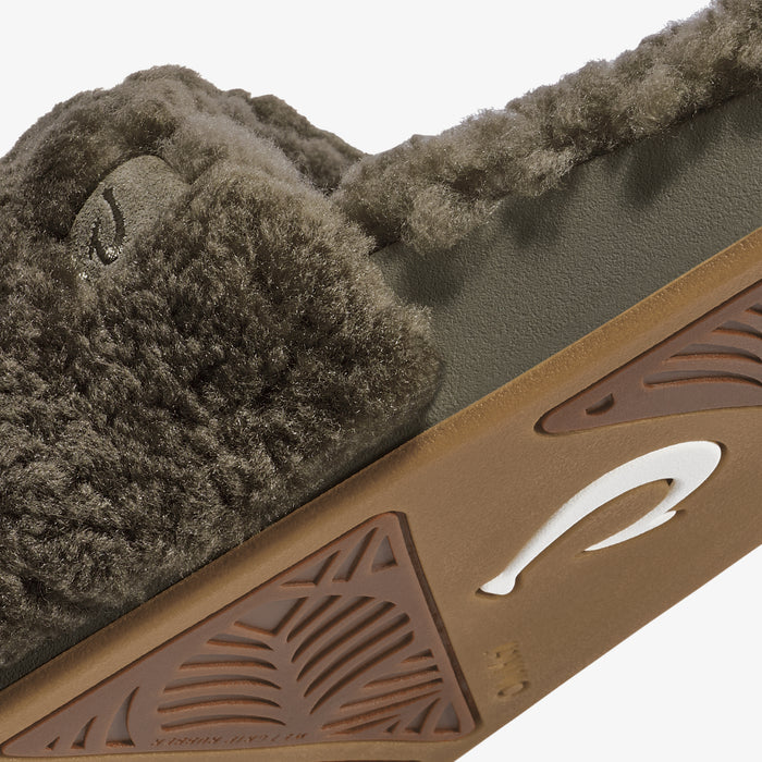 Walnut-colored leather sandal with carved geometric details and olive-toned wool upper lining visible from side angle.