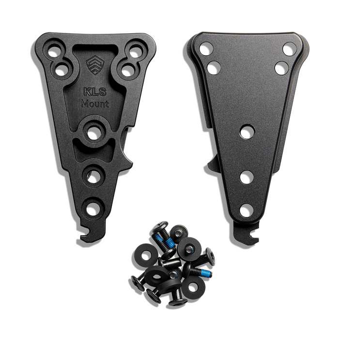 A pair of black aluminum KLS Mount brackets with a small pile of mounting hardware including screws, washers, and black washers, displayed on a clean white background.