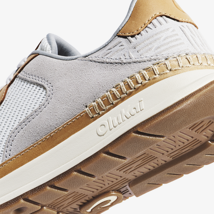 White and tan suede sneaker with mesh panels, cream midsole, and tan rubber outsole.