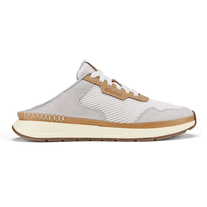 White and tan slip-on sneaker with mesh paneling, white laces, and cream-colored sole.
