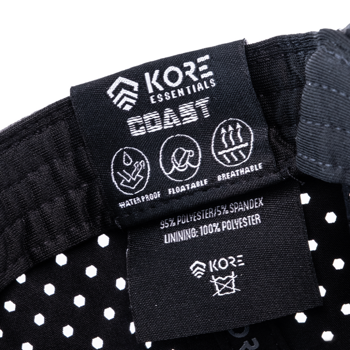 Close-up of Kore Essentials Coast Hat product label displaying the Waterproof, Floatable and Breathable Features of the Hat