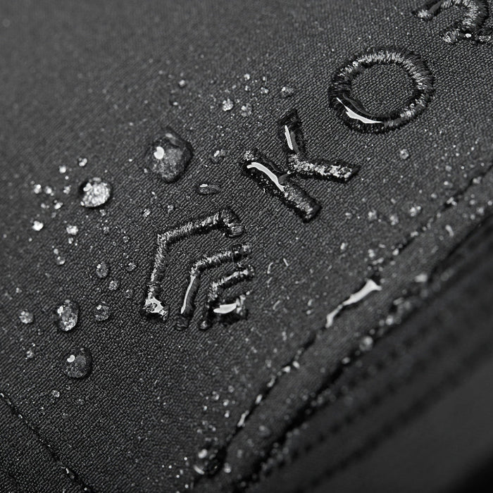 Closeup Shot of Black Kore Essentials Water Repellent Crew Hat with Grey Kore Logo on Front of Hat Showcasing Water Repellent Feature