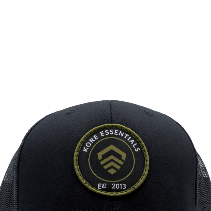 Closeup View of Black Kore Essentials Trucker Cap with Kore Logo Embroidered on Front