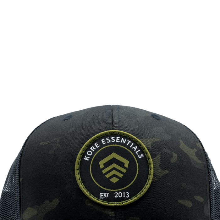 Closeup View of Multicam® Black Kore Essentials Trucker Cap with Kore Logo Embroidered on Front