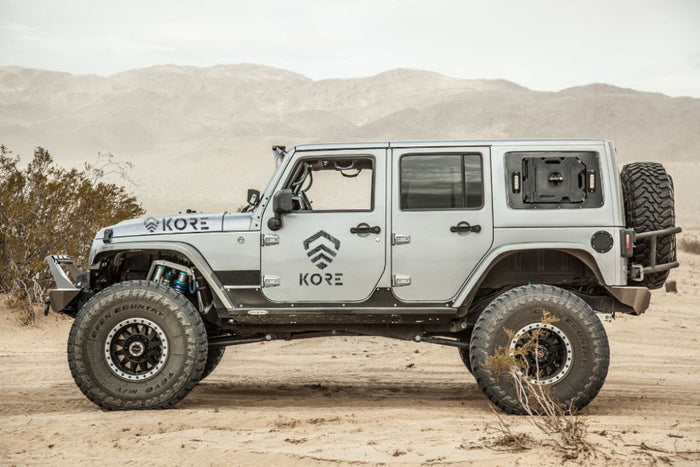 Kore Essentials Logo Decals Affixed to the Side of a Jeep in the Desert