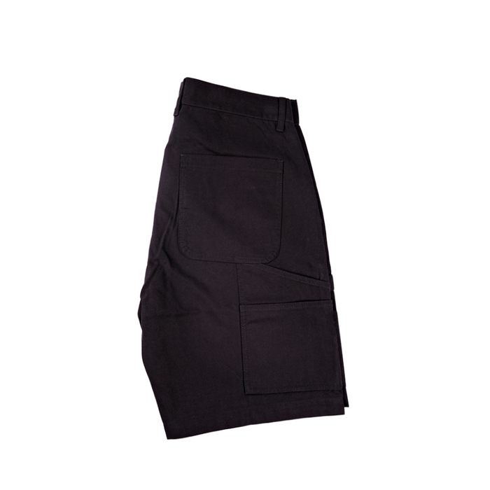 Side view of black Kore Essentials utility shorts on a white background