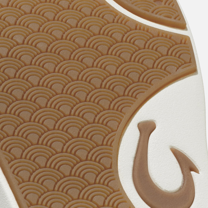 Tan and white sandal sole with geometric arc pattern and hook detail.