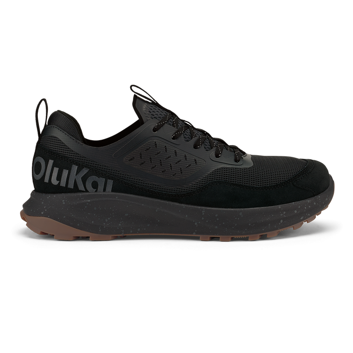 Black lace-up trail running shoe with mesh and suede upper, speckled midsole, and tan rubber outsole.