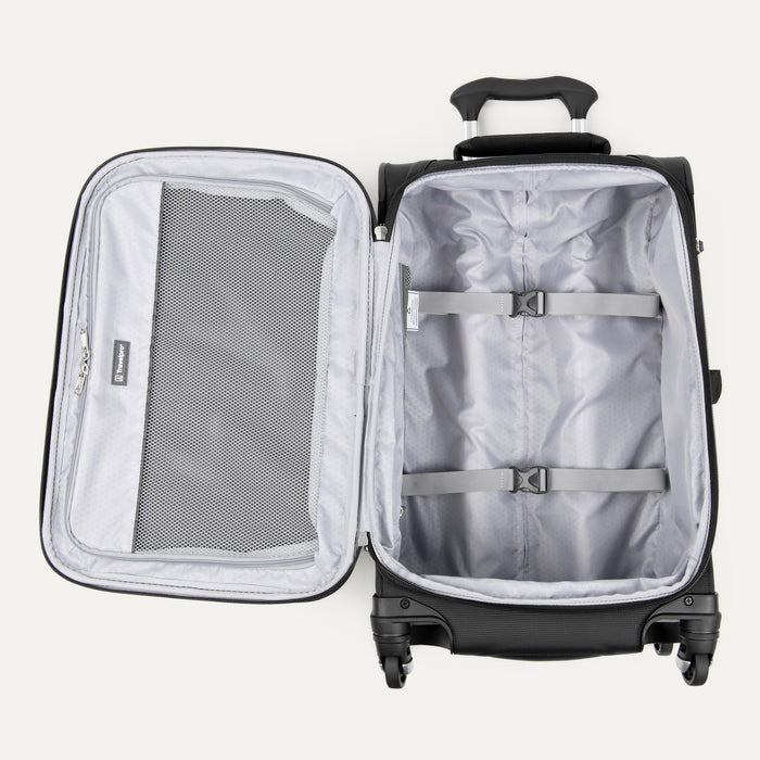 interior view of open black travelpro maxlite 5 compact carry-on spinner showing gray lining with adjustable compression straps and a large mesh lid pocket.