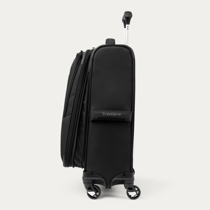 side profile view of black travelpro maxlite 5 compact carry-on spinner showing the slim design four wheel spinner system and telescoping handle.